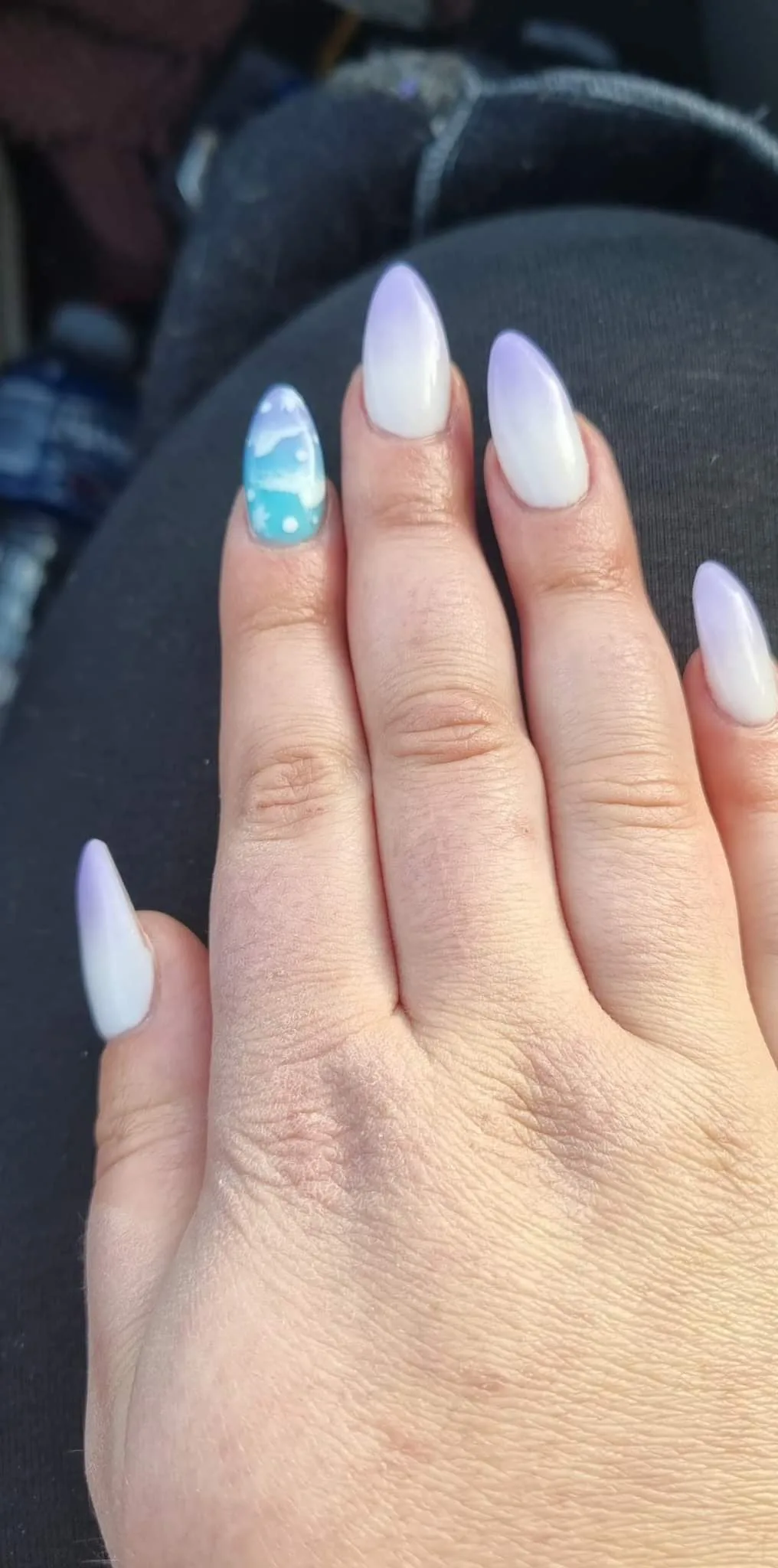 White and lilac ombre almond nails with a hand-painted teal beach-scene accent nail
